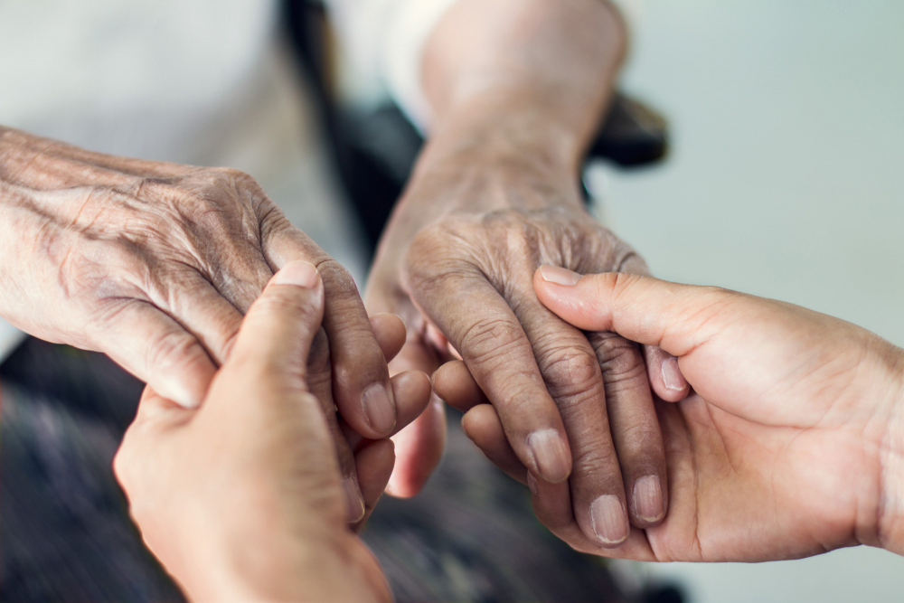 close up hands helping hands elderly home care